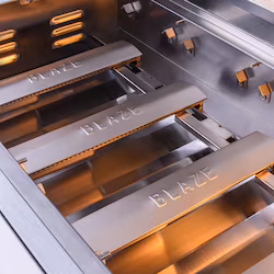 Detailed view of cast stainless steel burners on Blaze LTE+ Built-In NG Grill with IR Burner