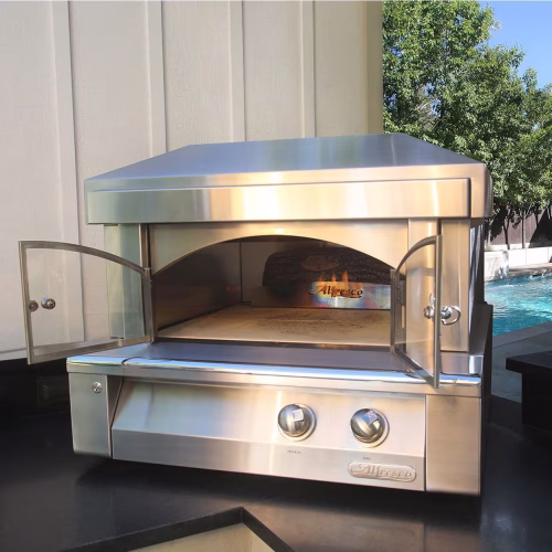 Front angle of the Alfresco 30-Inch Countertop Pizza Oven installed in a luxury outdoor kitchen in Naples, FL