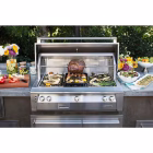 Whole chicken roasting on the rotisserie rod inside the Alfresco ALXE 42" Built-In NG Grill With Sear Zone & Rotisserie with rear ceramic burner glowing