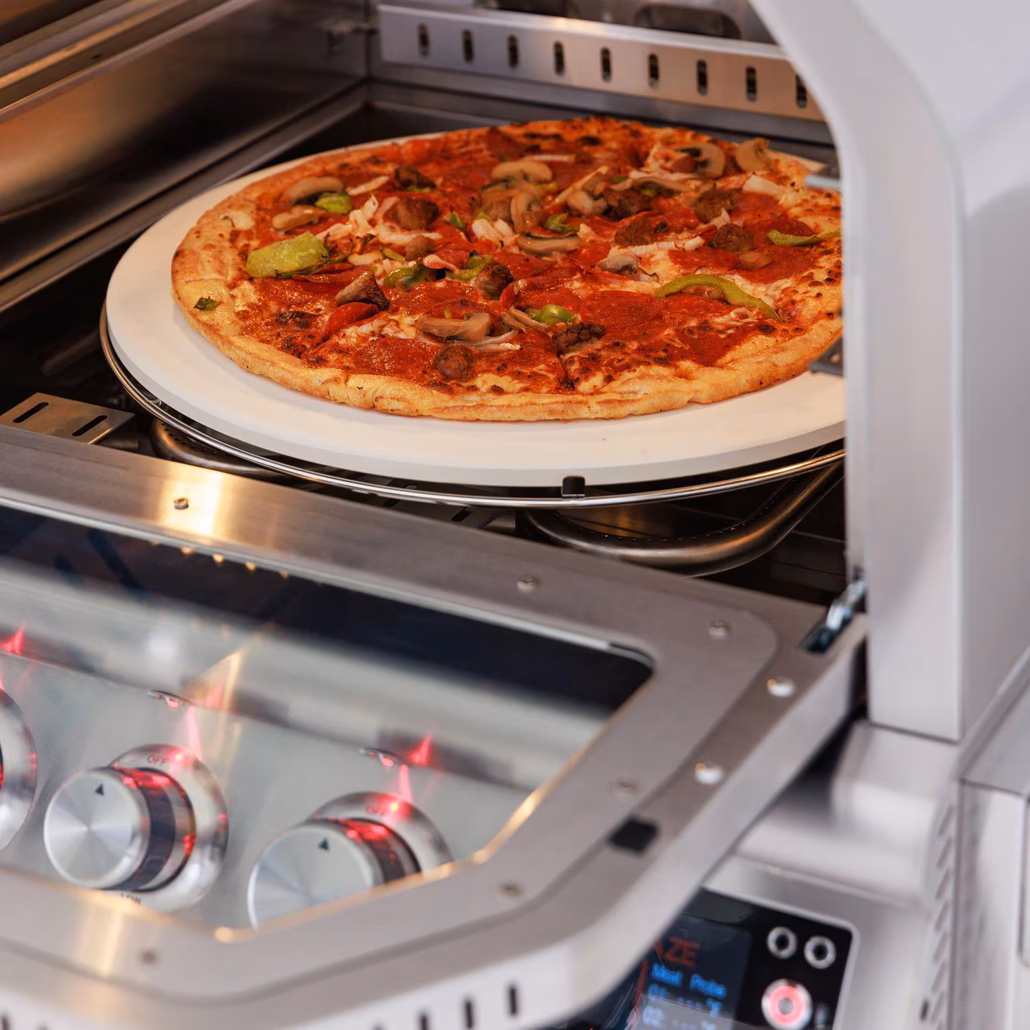 The Blaze 26" Built-In Outdoor Oven (Model BLZ-26-PZOVN-LP with pizza on stone